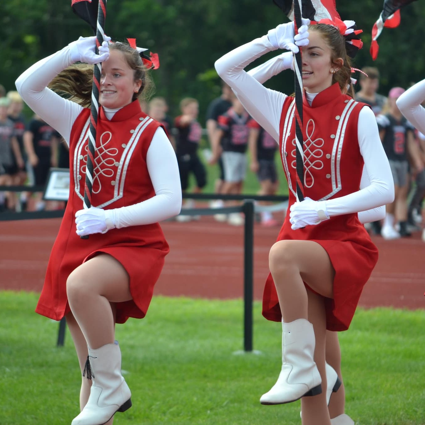 Morgan S. and Kayla R. lead the Flag Line in for the Back-to-School Bash. 