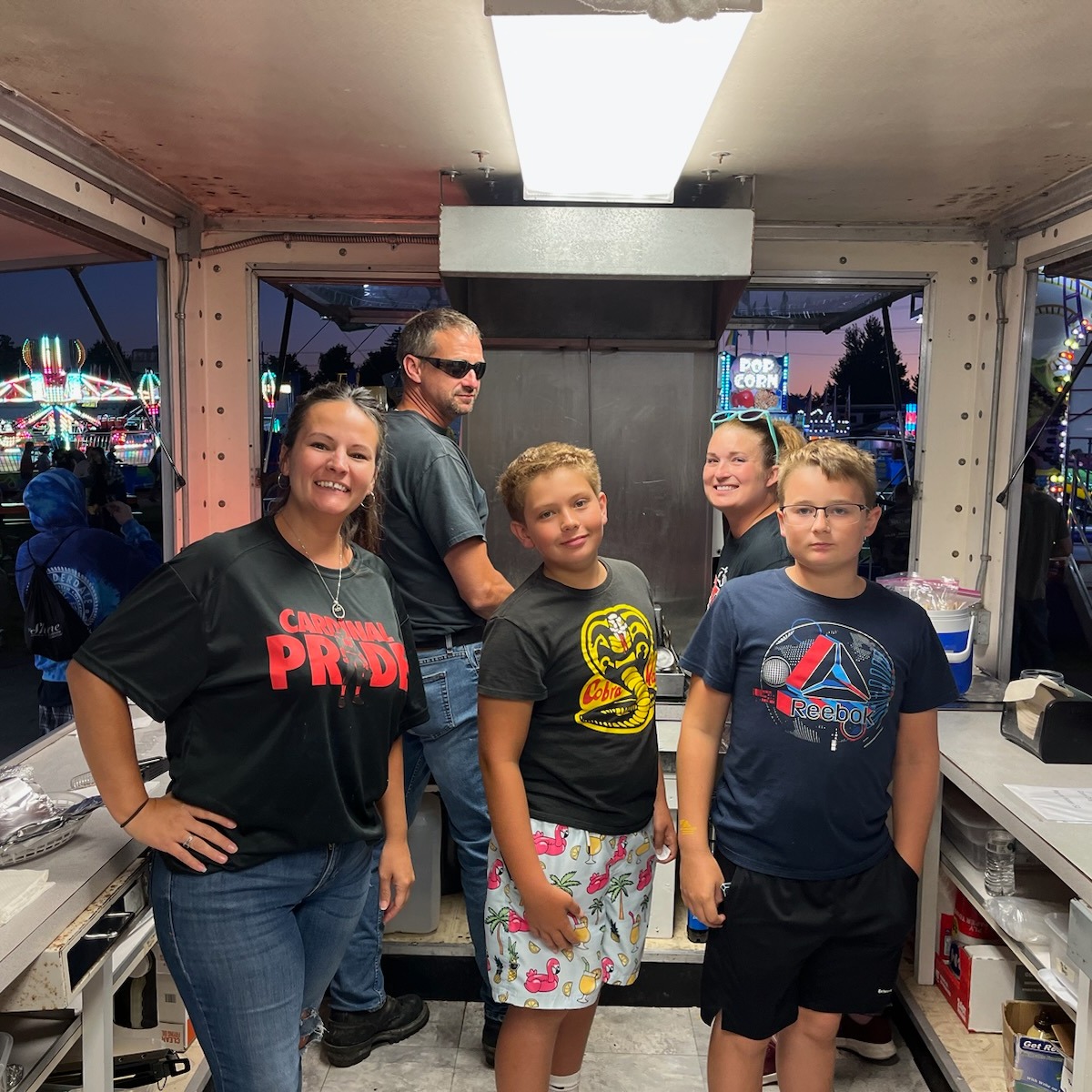 Parents and volunteers working the Cheese Booth at the Geauga County Fair. 