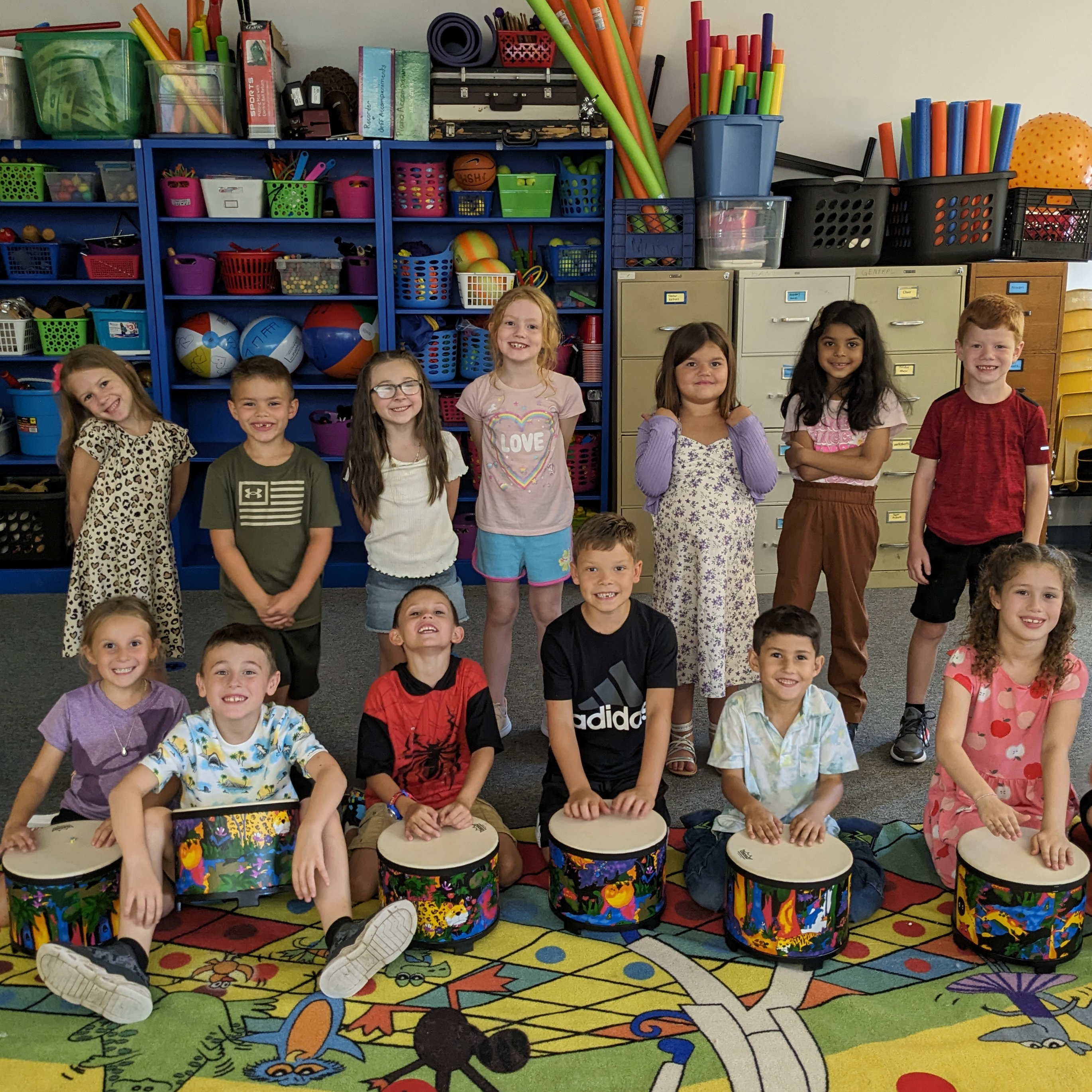 First graders pose with a picture of their new drum sets that Mrs. Mujanovic won through a grant. 
