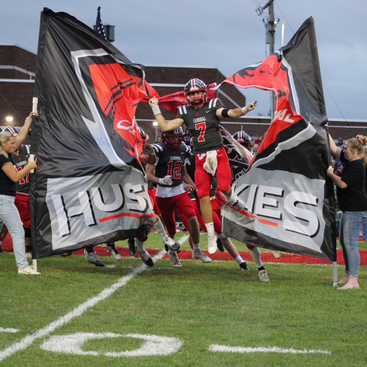 Cardinal Huskies Football team gathers together for the coin toss and captains meeting. 