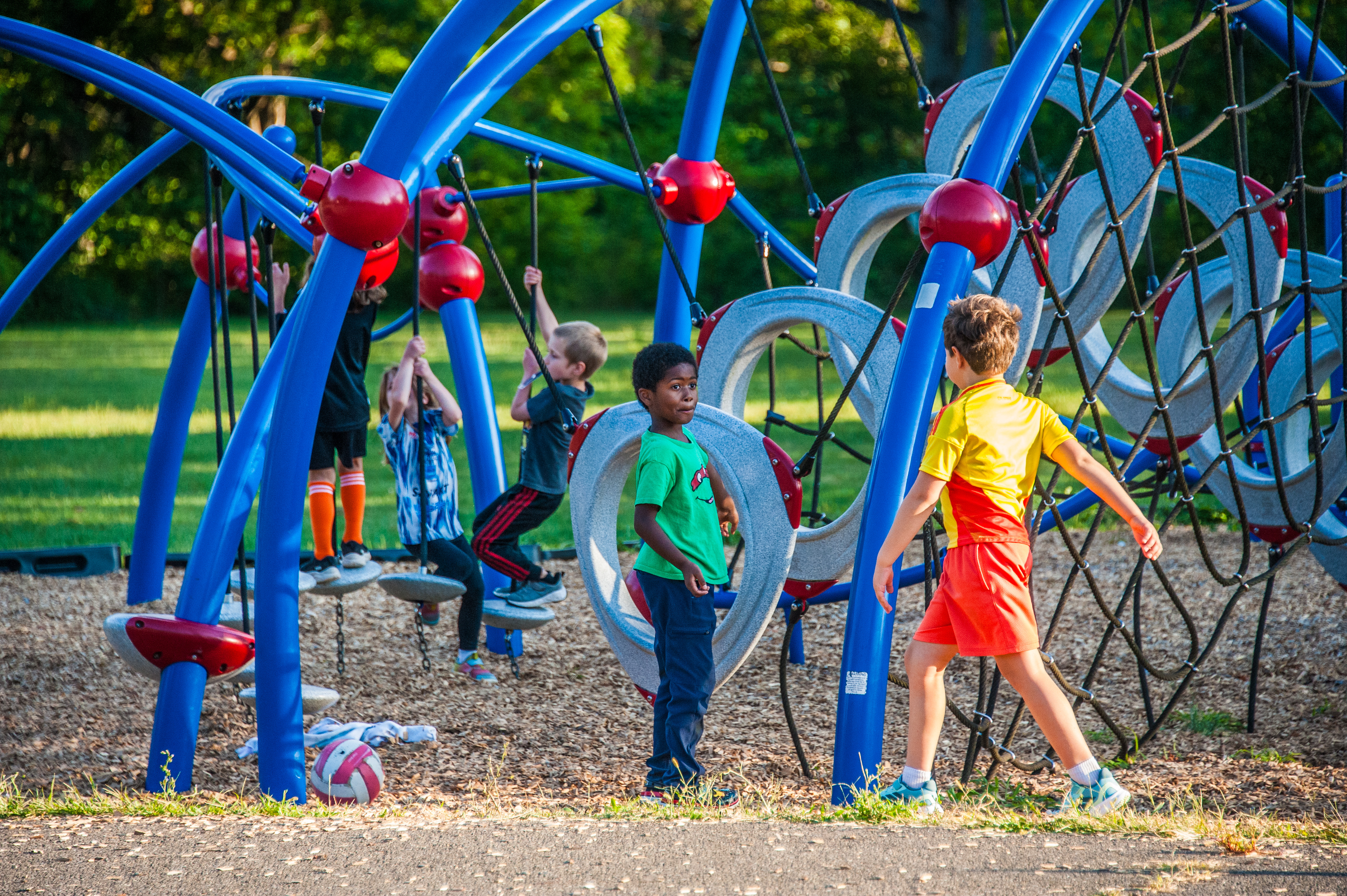 A group of five Cayuga Heights Elementary students play on the playground.