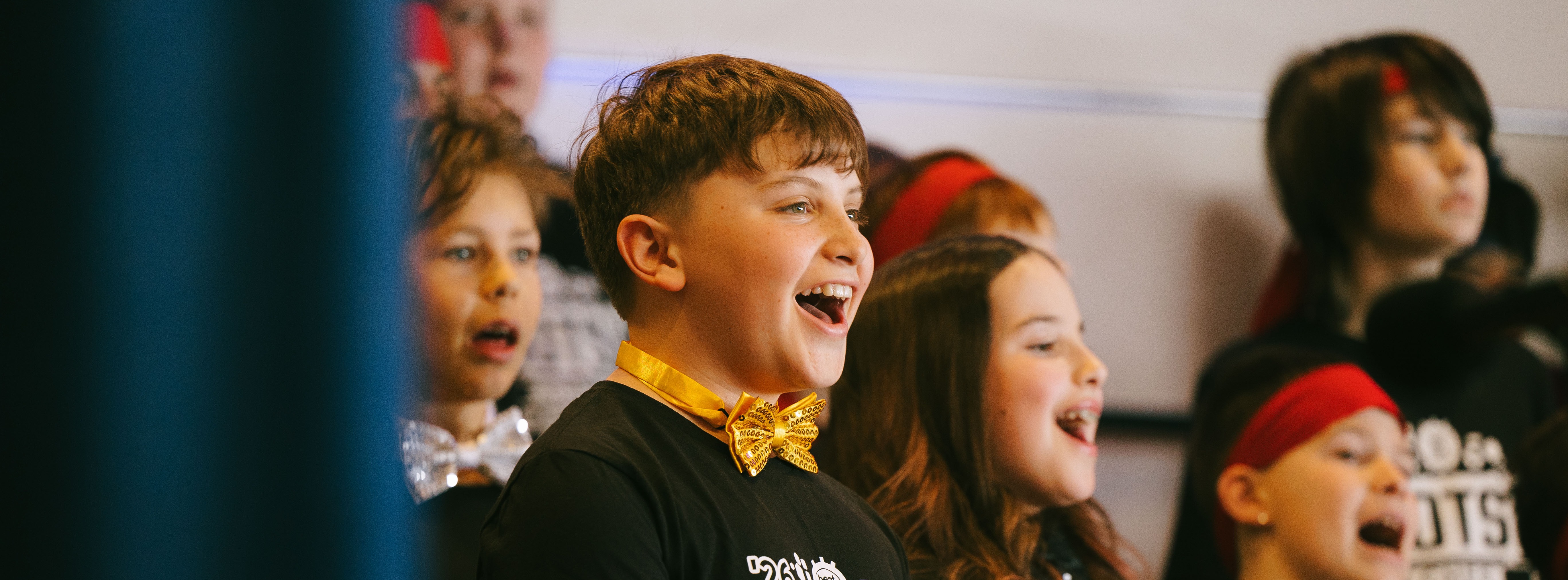 CHES fifth grader on stage singing in the musical BOTS!