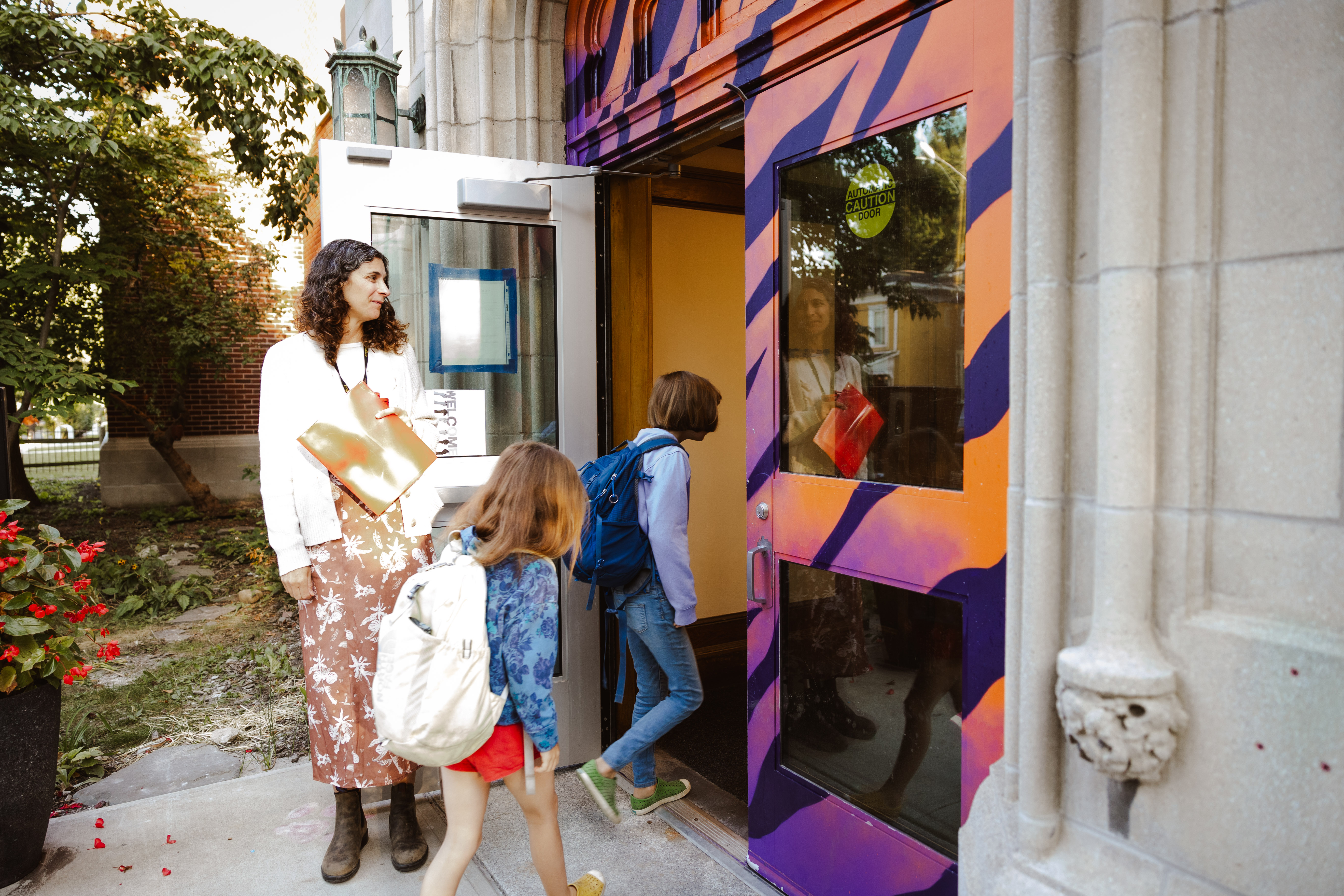 Students entering BJM elementary through a colorful door. 