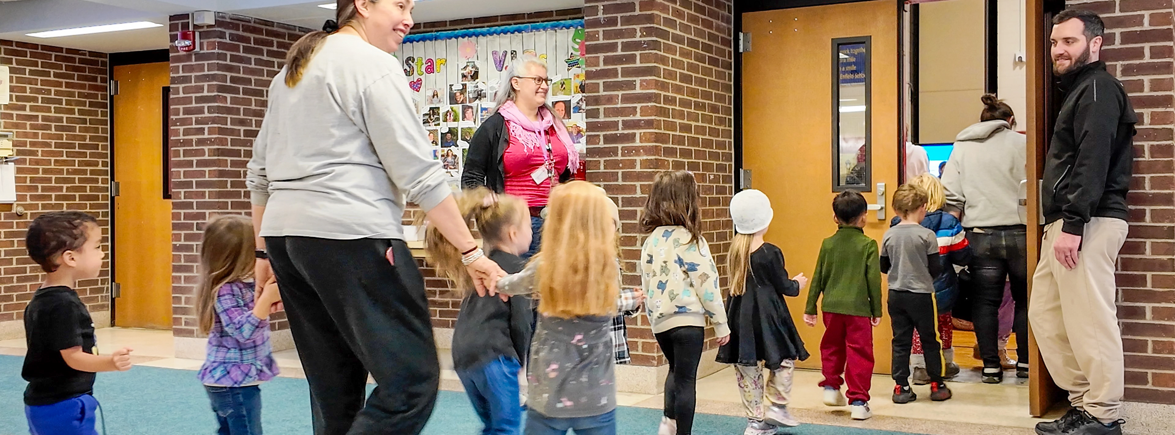 Enfield educators and students walking to the gym for an assembly