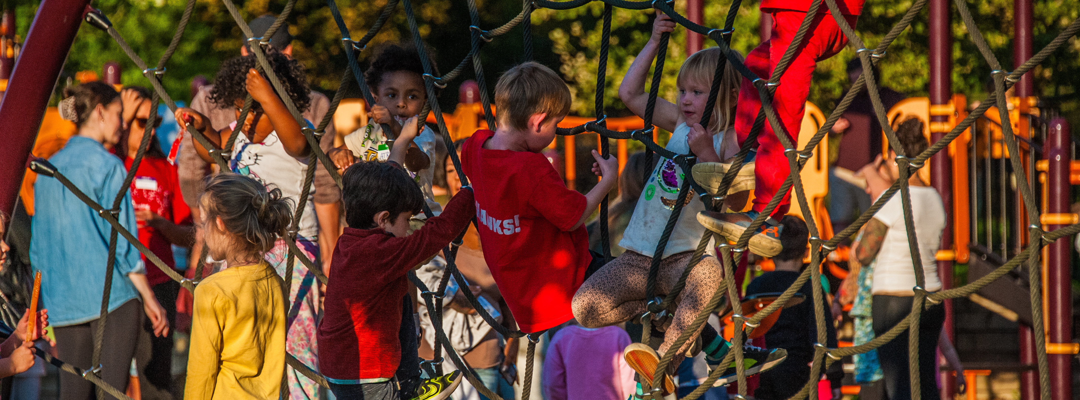 A group of South Hill Elementary students play on the climber on the school's playground during a back-to-school event