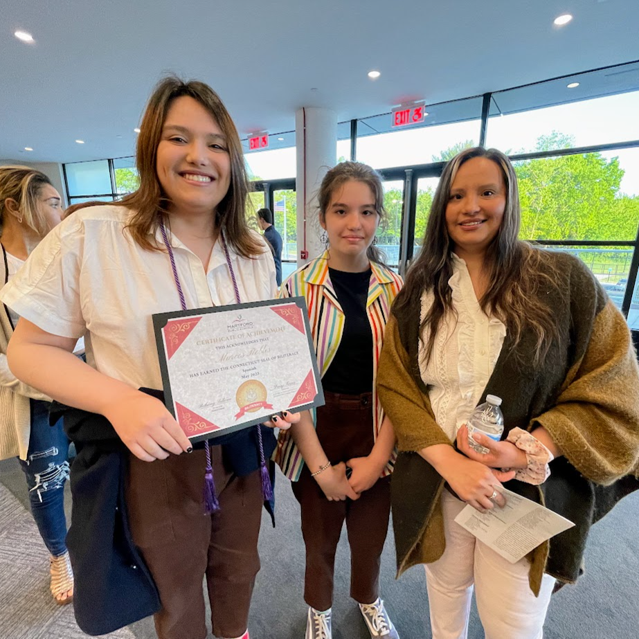 Proud High School student with Seal of Biliteracy certificate  and family