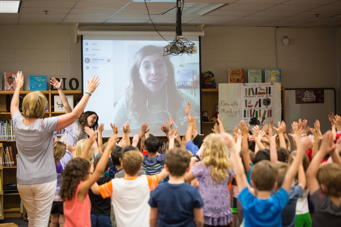 Cub Run Elementary students Skype with author, Emily Arrow, in the school library. Arrow's work blends story and song.