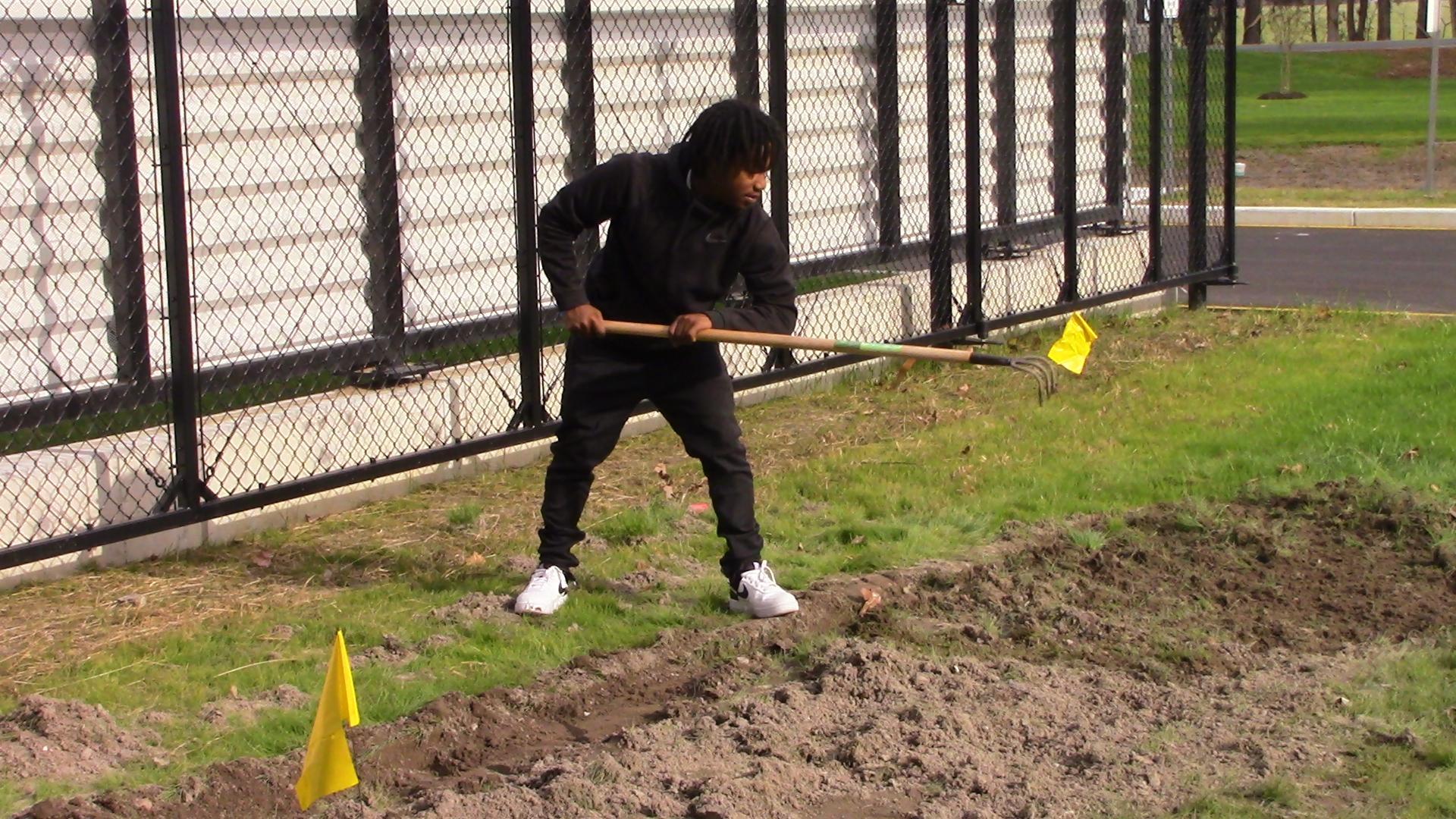 Student working at a garden at Horticulture class