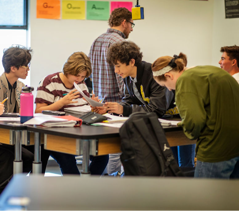 Teacher helping students