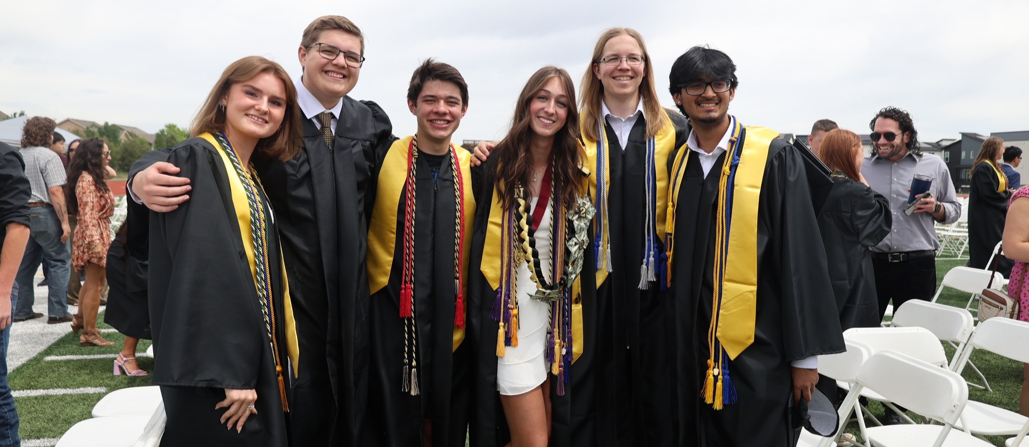 2025 Graduate smiles and celebrates