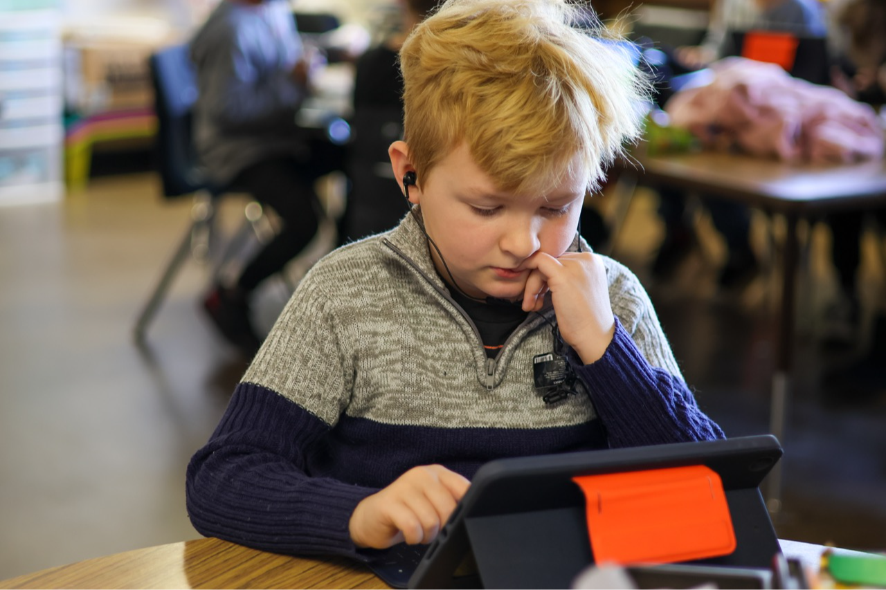 male elementary student on ipad