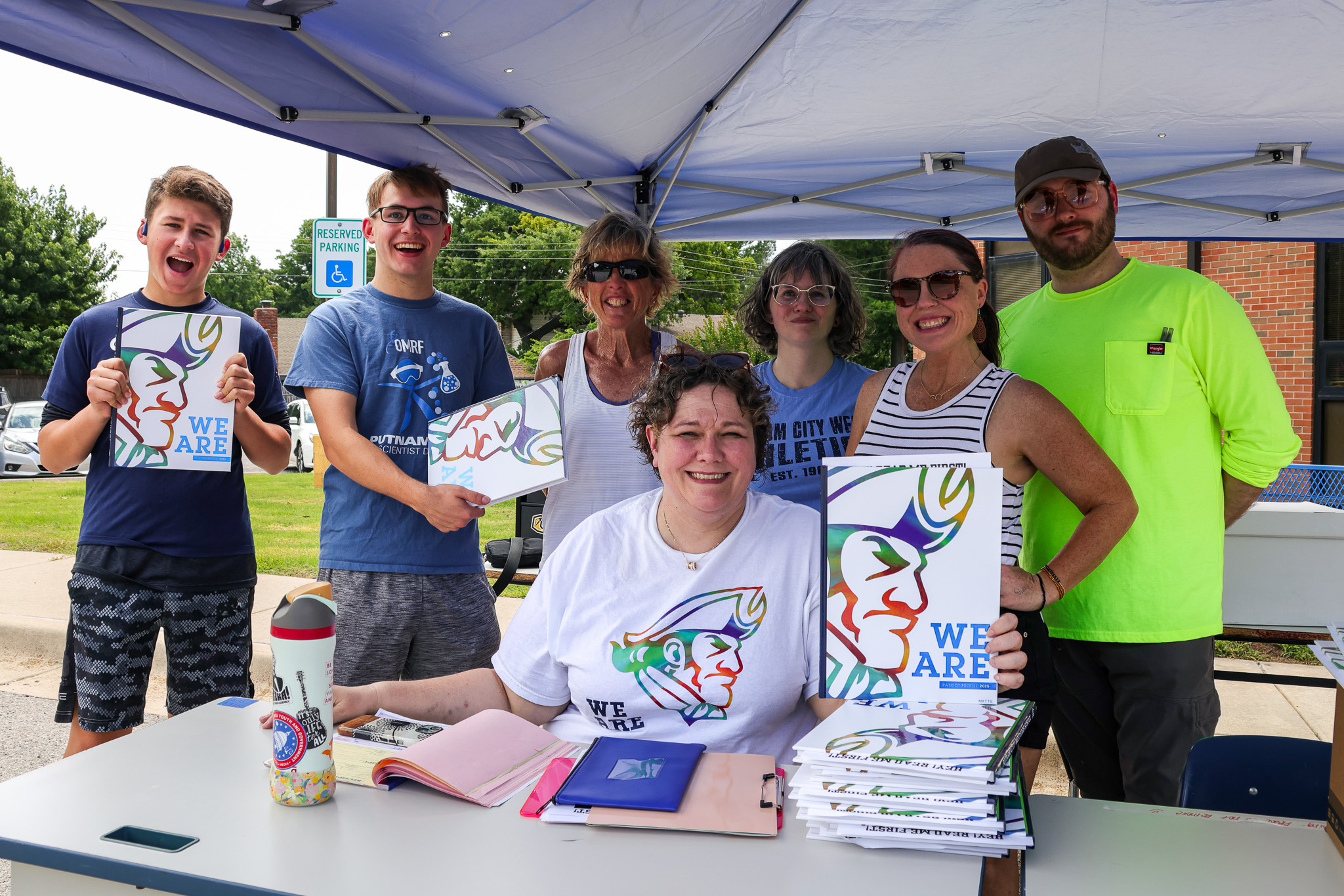 teachers and students with yearbooks