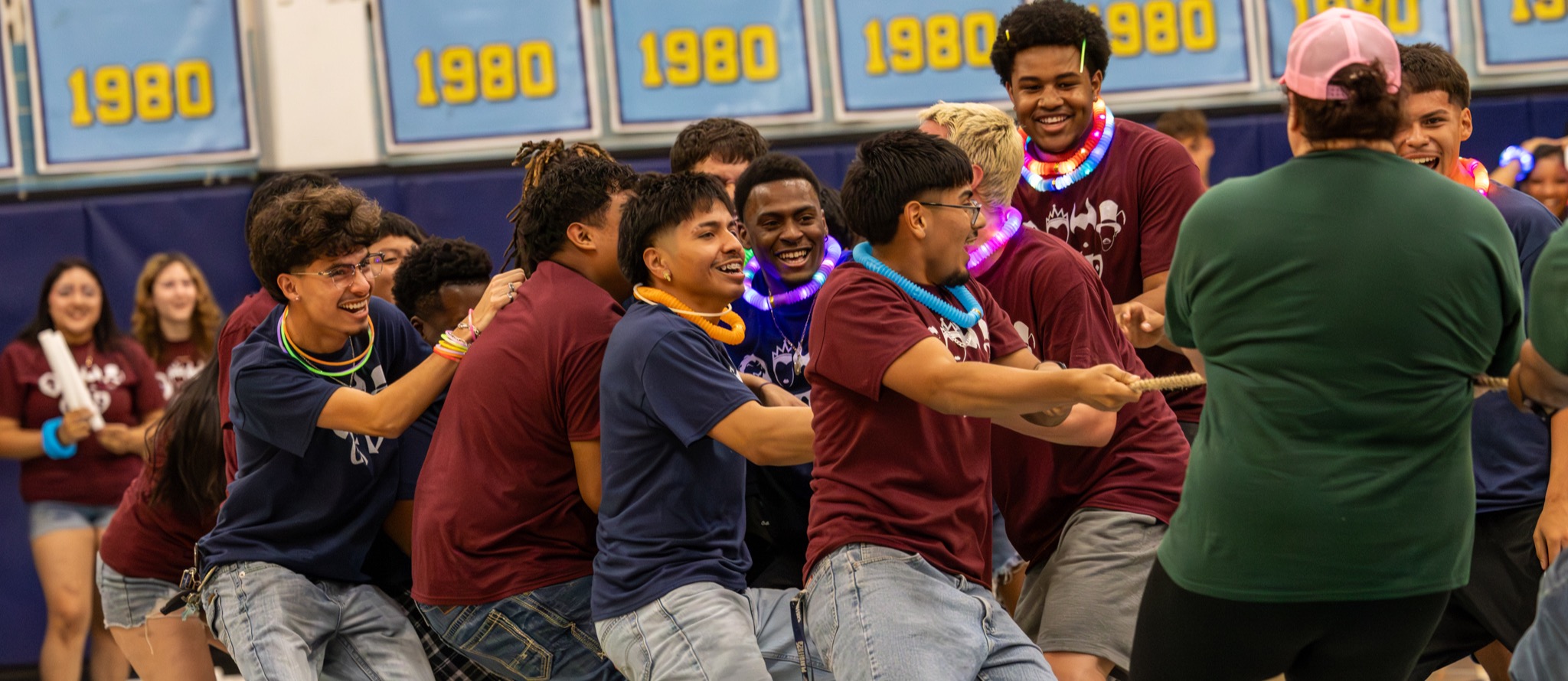Students wearing matching "CFD" shirts pull on a rope during tug of war
