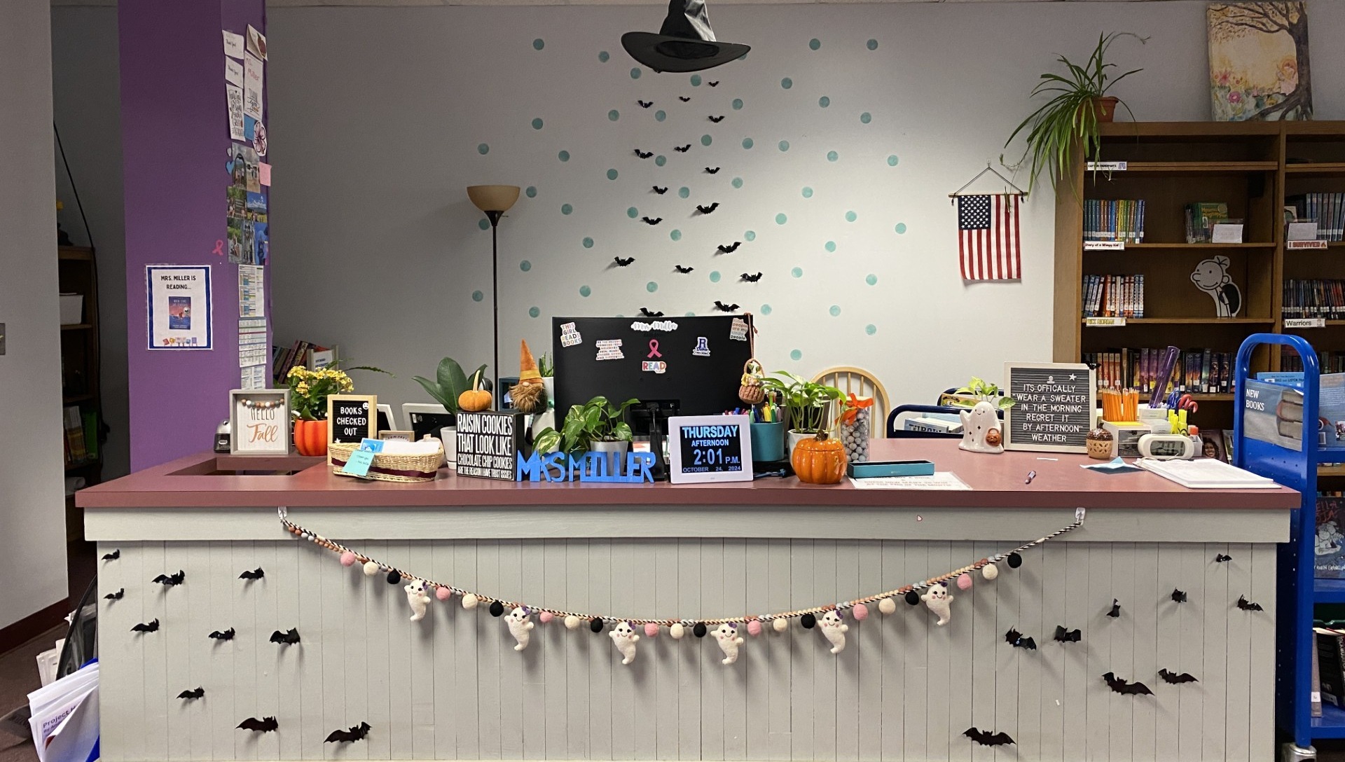 Photo of the library desk when you walk into the library decorated for halloween