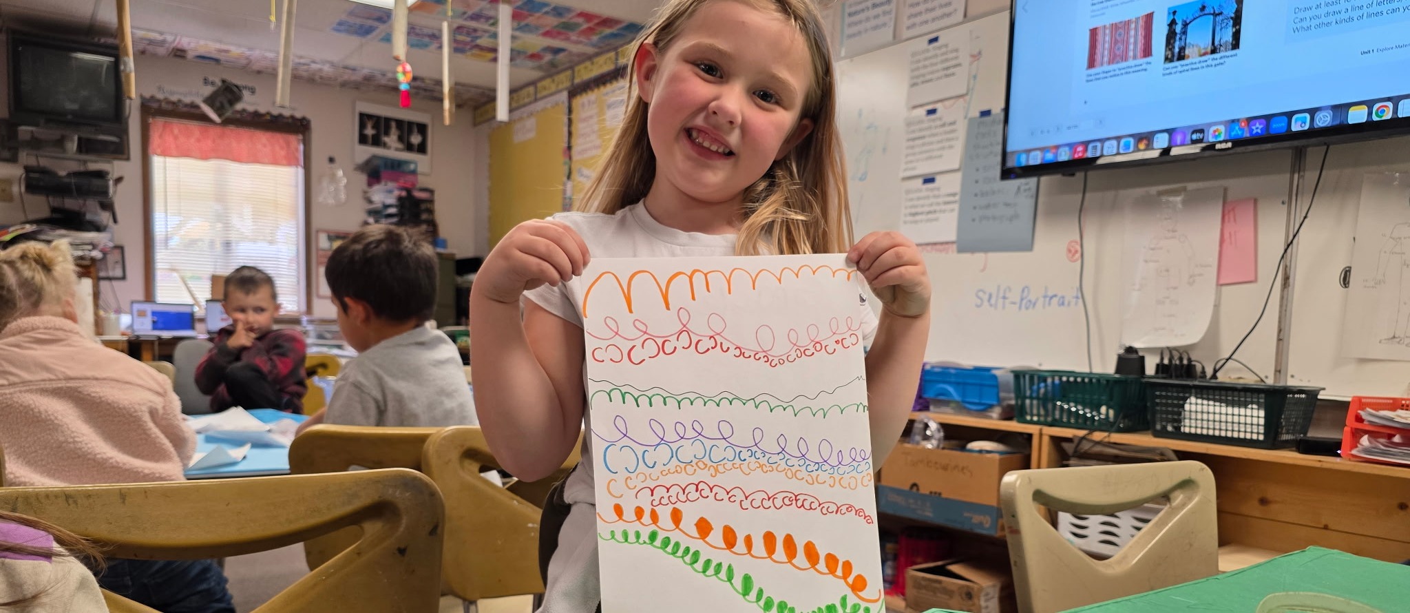 student showing her artwork