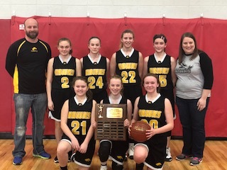 photo of the girls basketball team holding a trophy