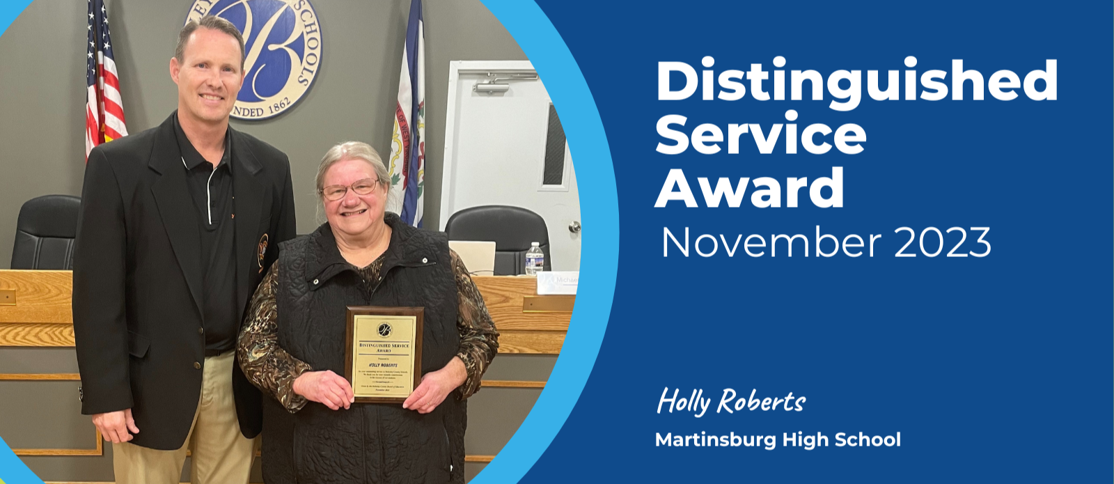 image of November 2023 Distinguished Service Award recipient holly roberts standing with principal trent sherman