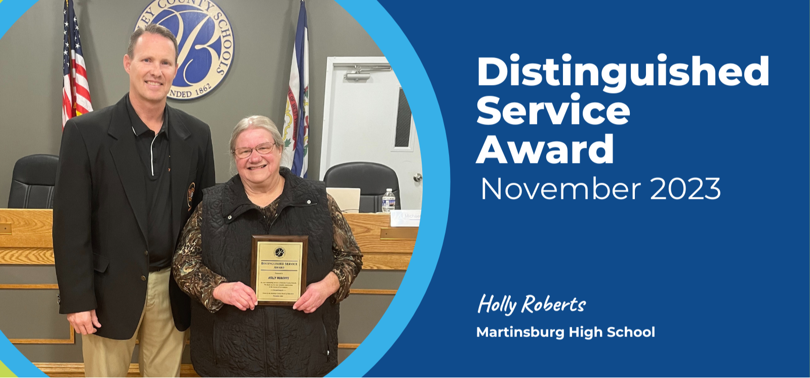 image of distinguished service award recipient holly roberts standing with principal trent sherman