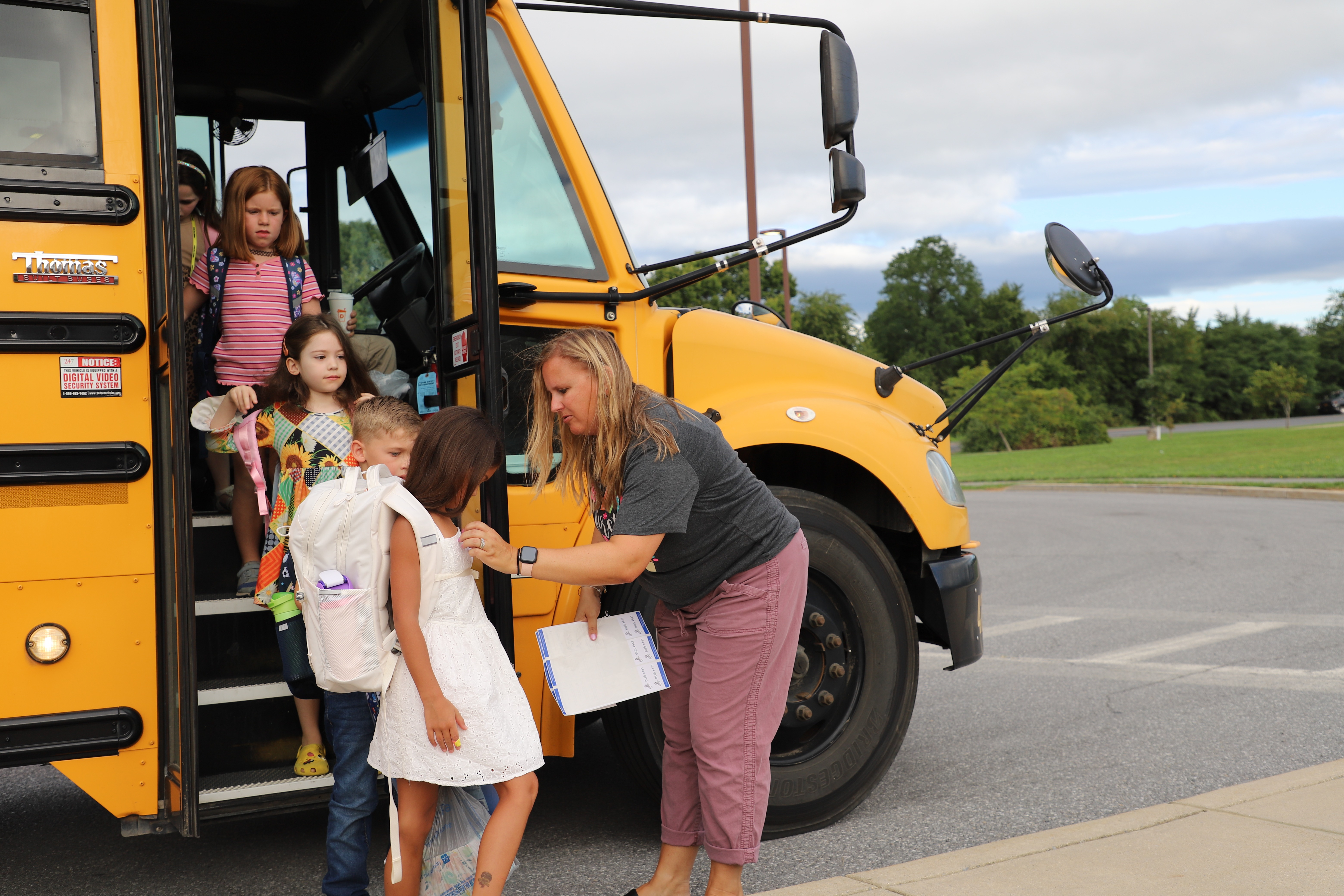 students getting off of a bus