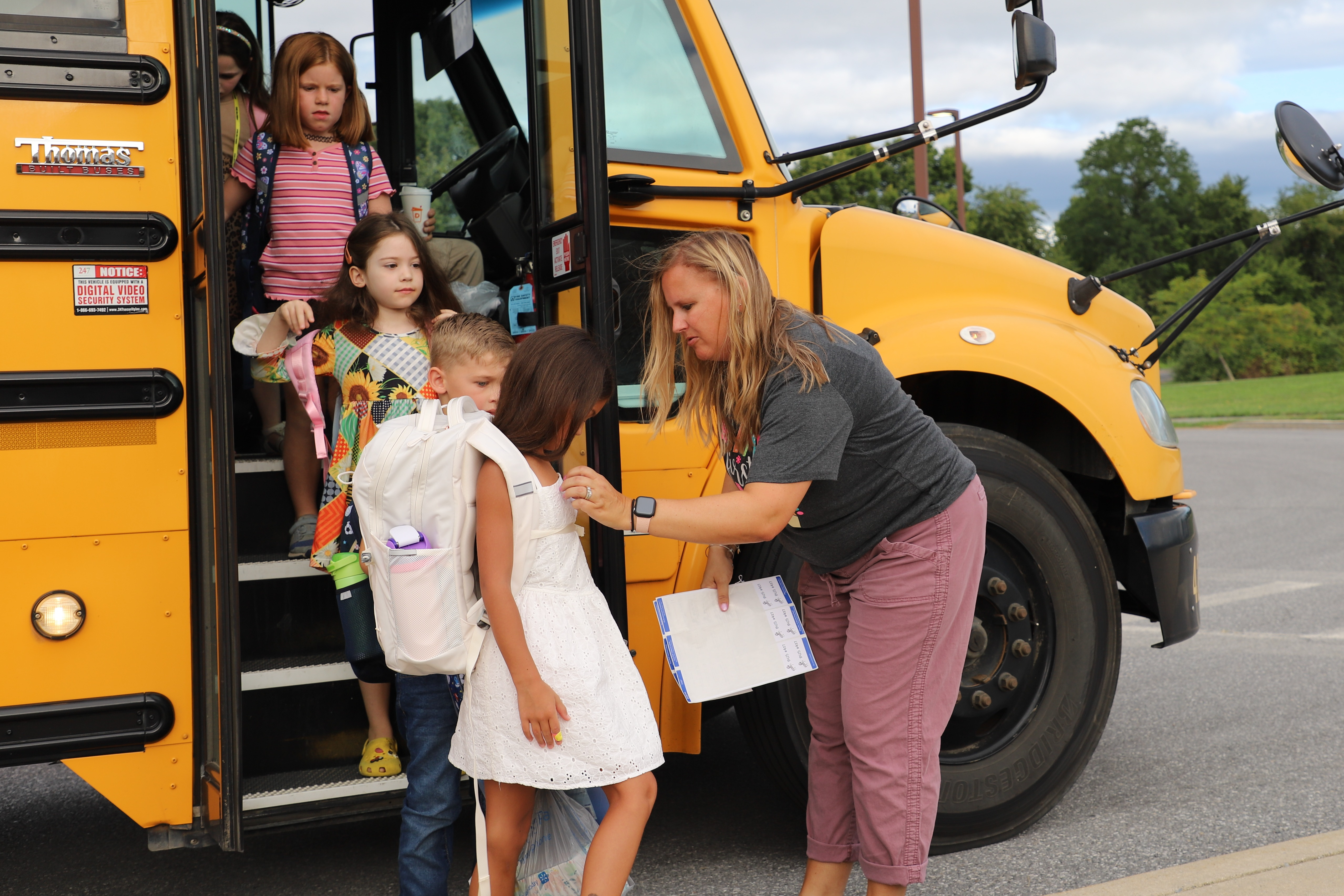 students getting off of a bus