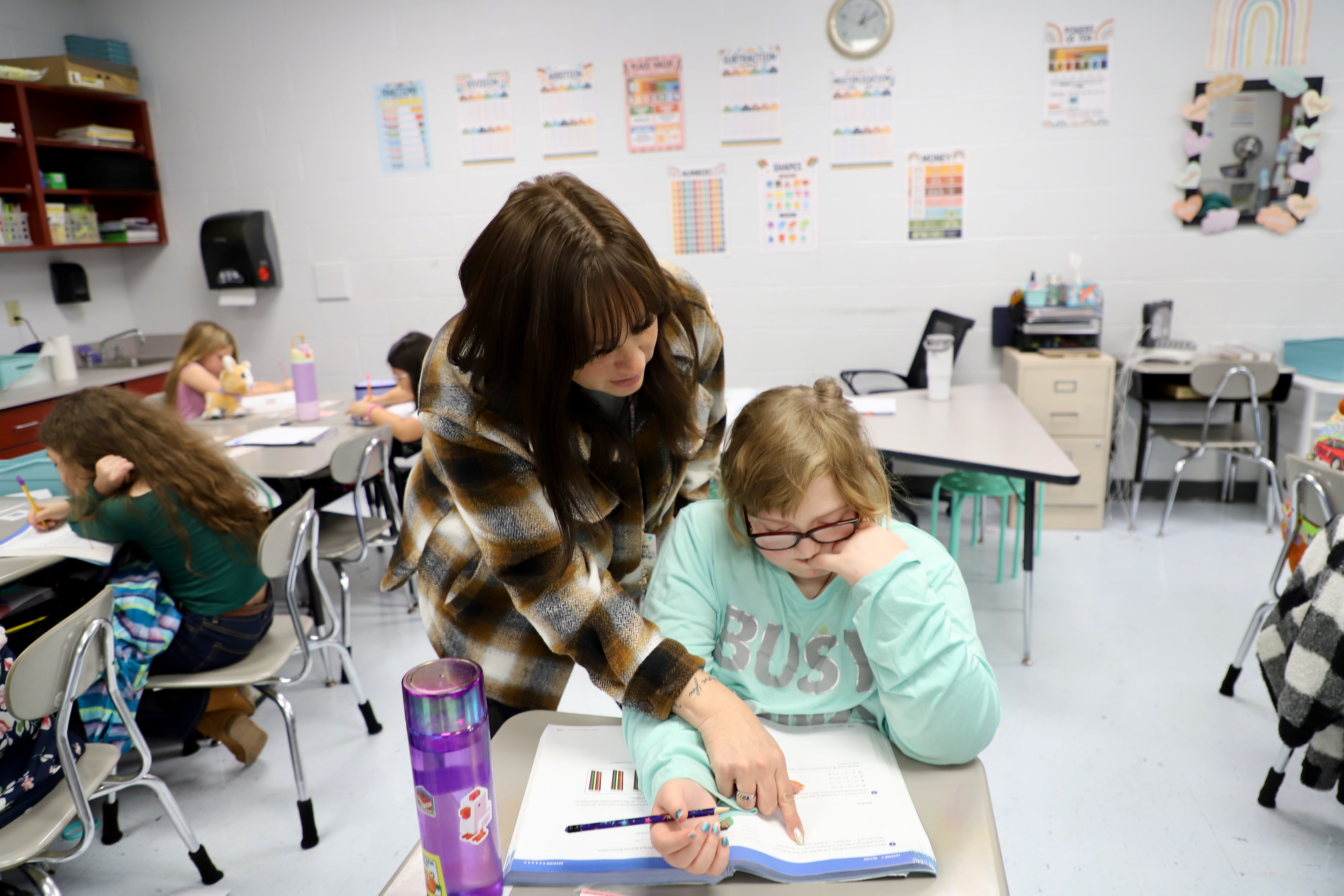 teacher interacting with students in classroom