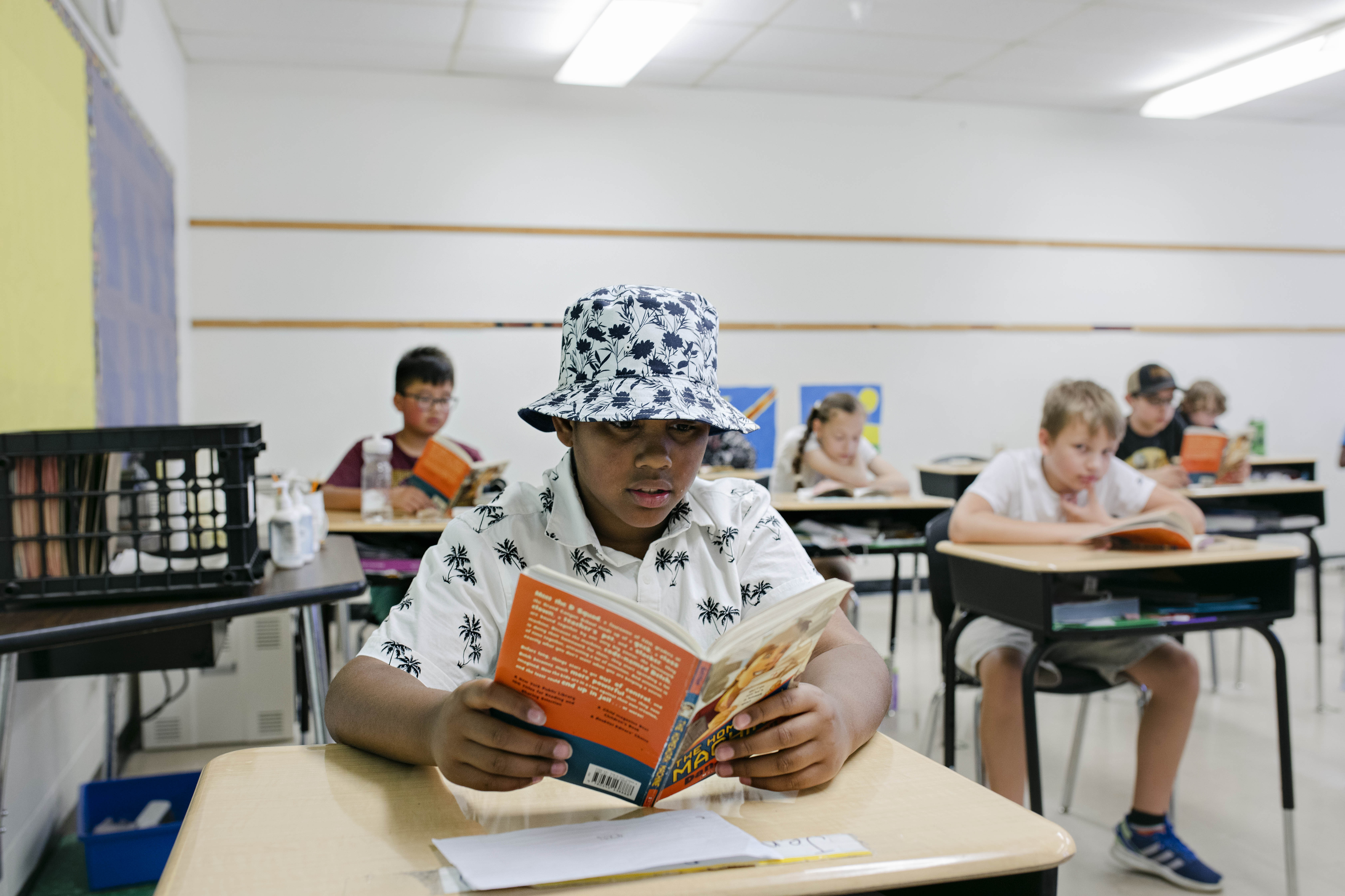 student reading a book in class