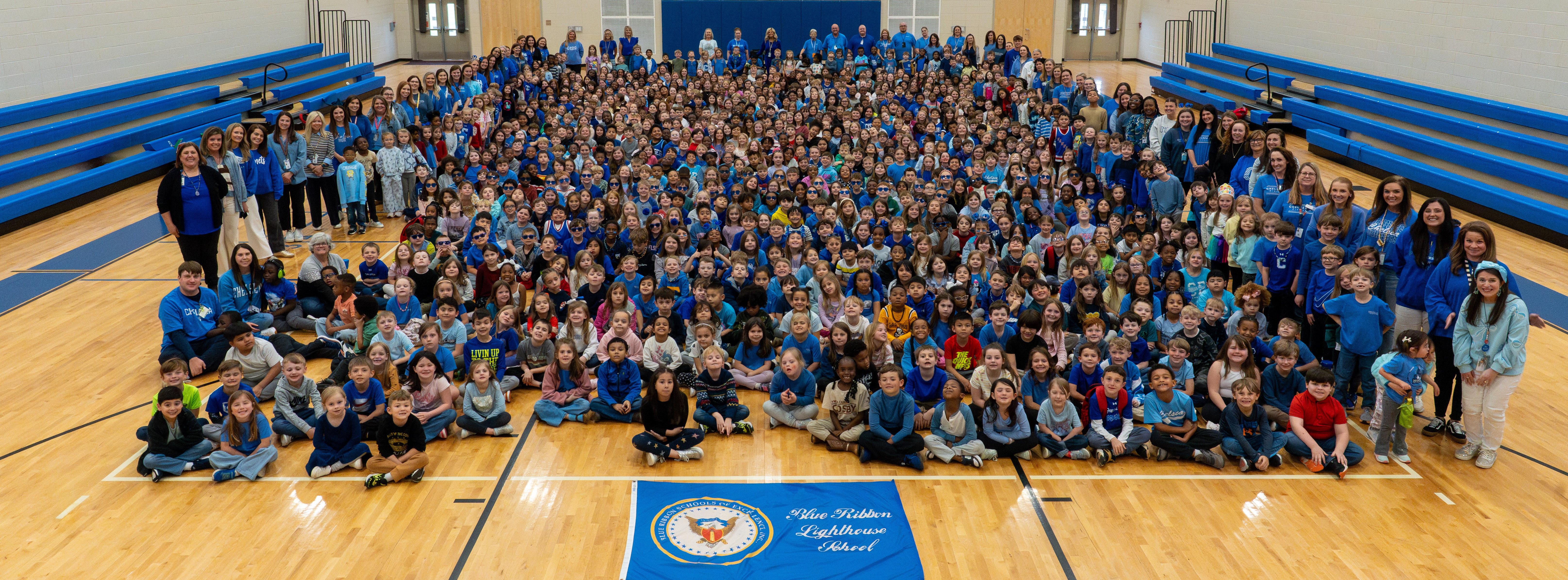 CPES STUDENTS AND FACULTY WITH BLUE RIBBON SIGN