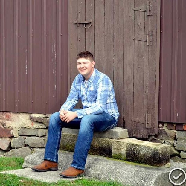 Landan Fry poses on steps for senior picture