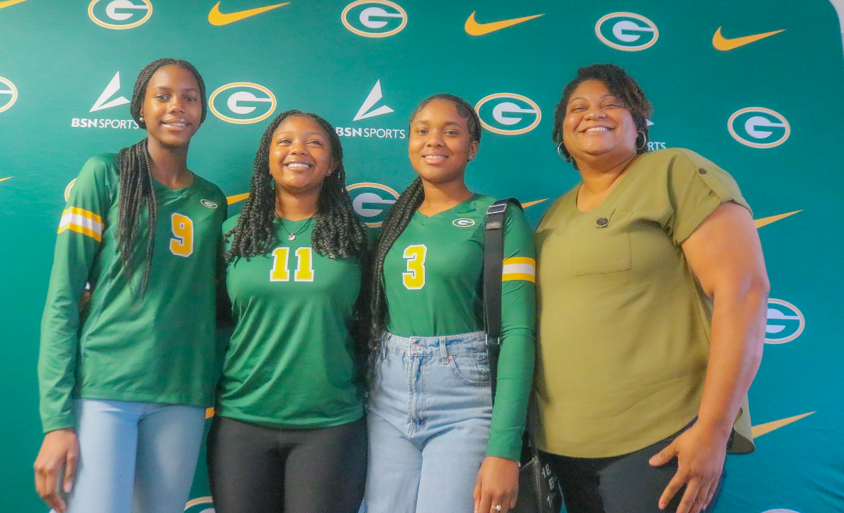 GHS volleyball in front of photo backdrop