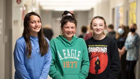 3 students smiling