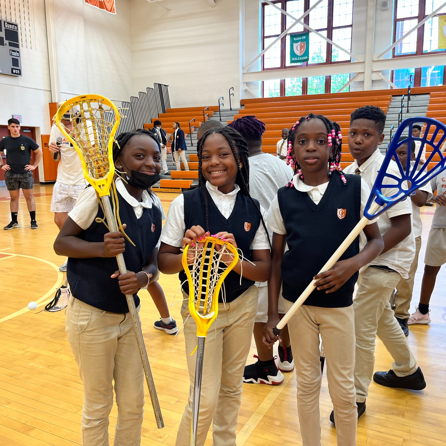 middle school students with lacrosse sticks