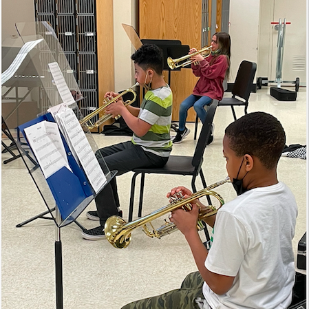 fifth graders playing the trumpet