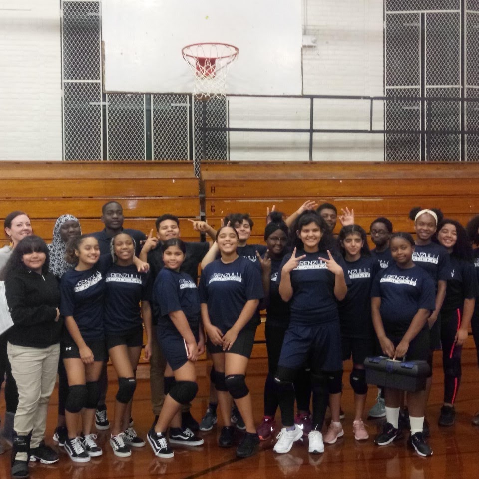 basket ball students all posing in the gym with basketballs 