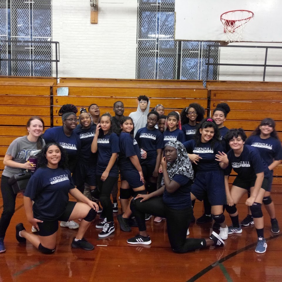 basket ball students all posing in the gym with basketballs 