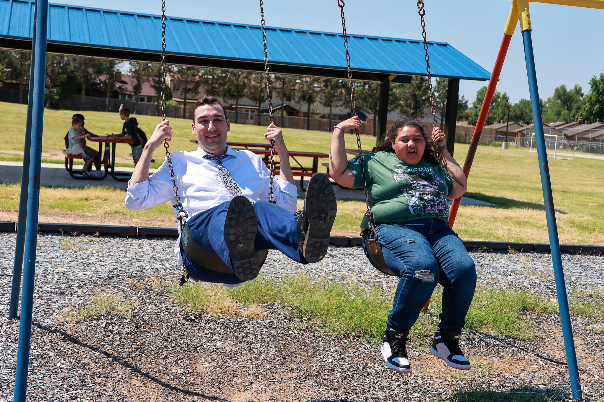 student and teacher on swings