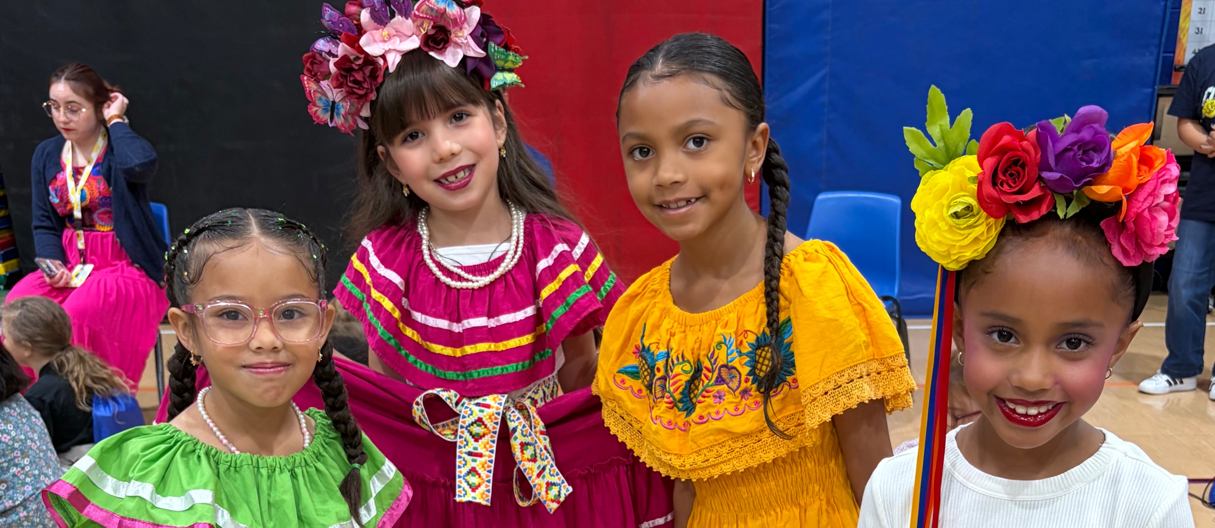 Group of students in traditional Hispanic outfits.
