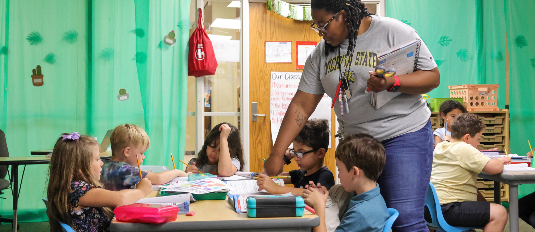 teacher helping students