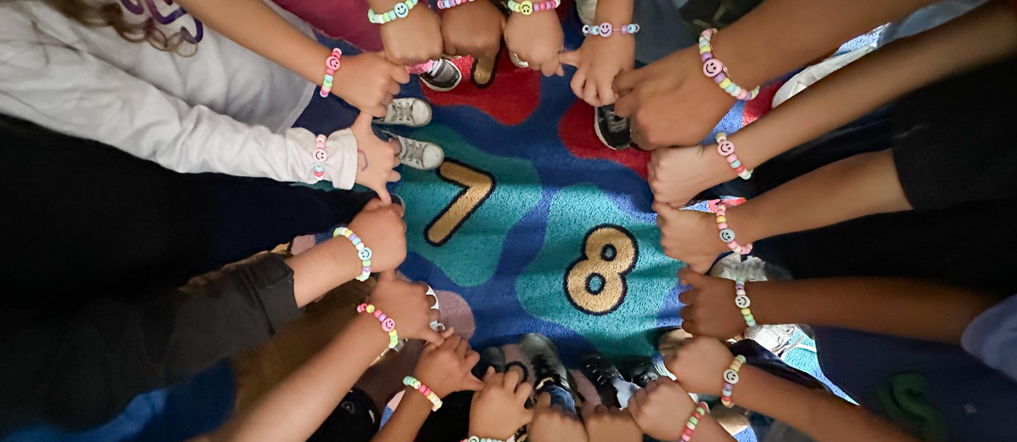 students holding hands in circle