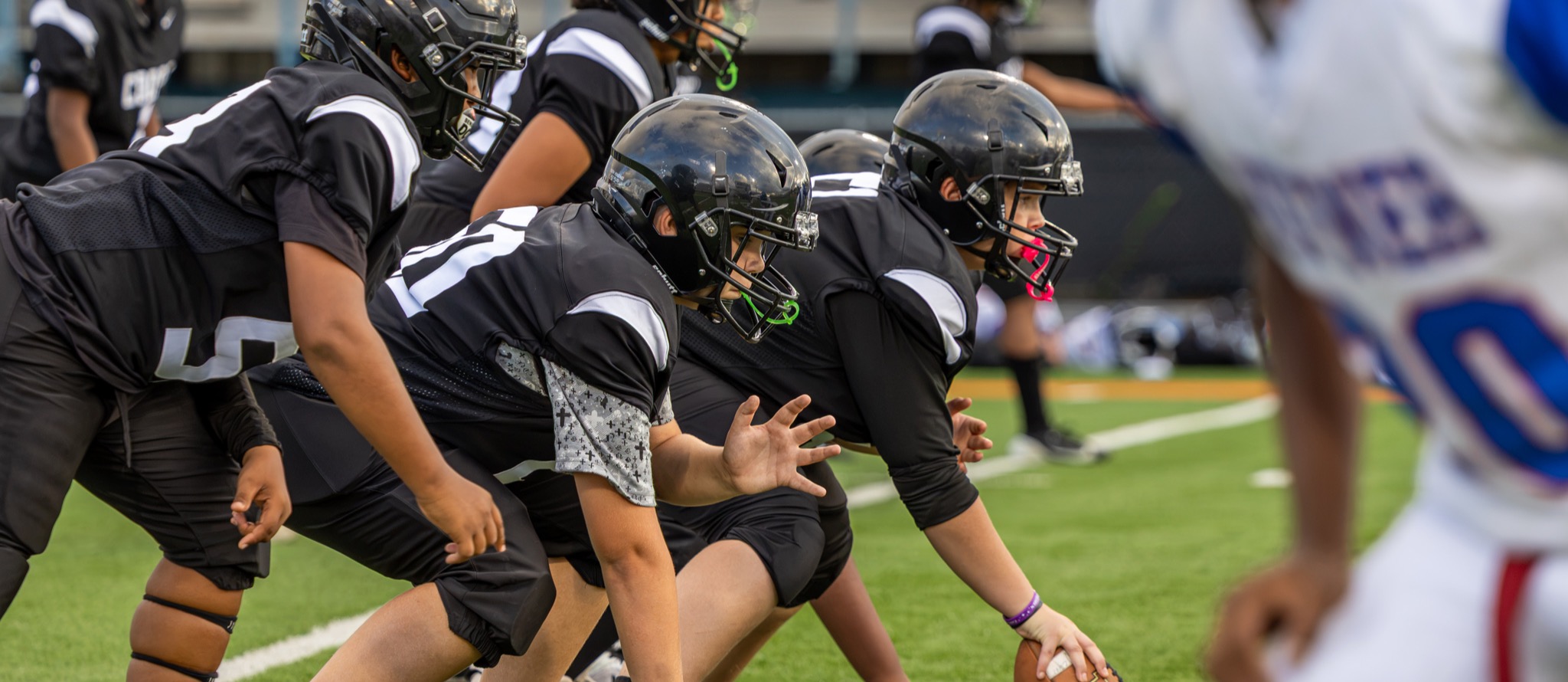 Cooper's offensive line prepares for the snap at a football game against Hefner