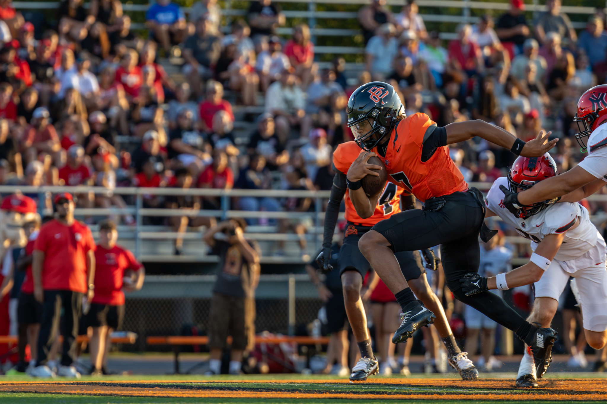 PC High football player running down the field ahead of the opposing team