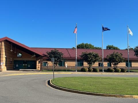 photo of AAES front entrance with flag poles 