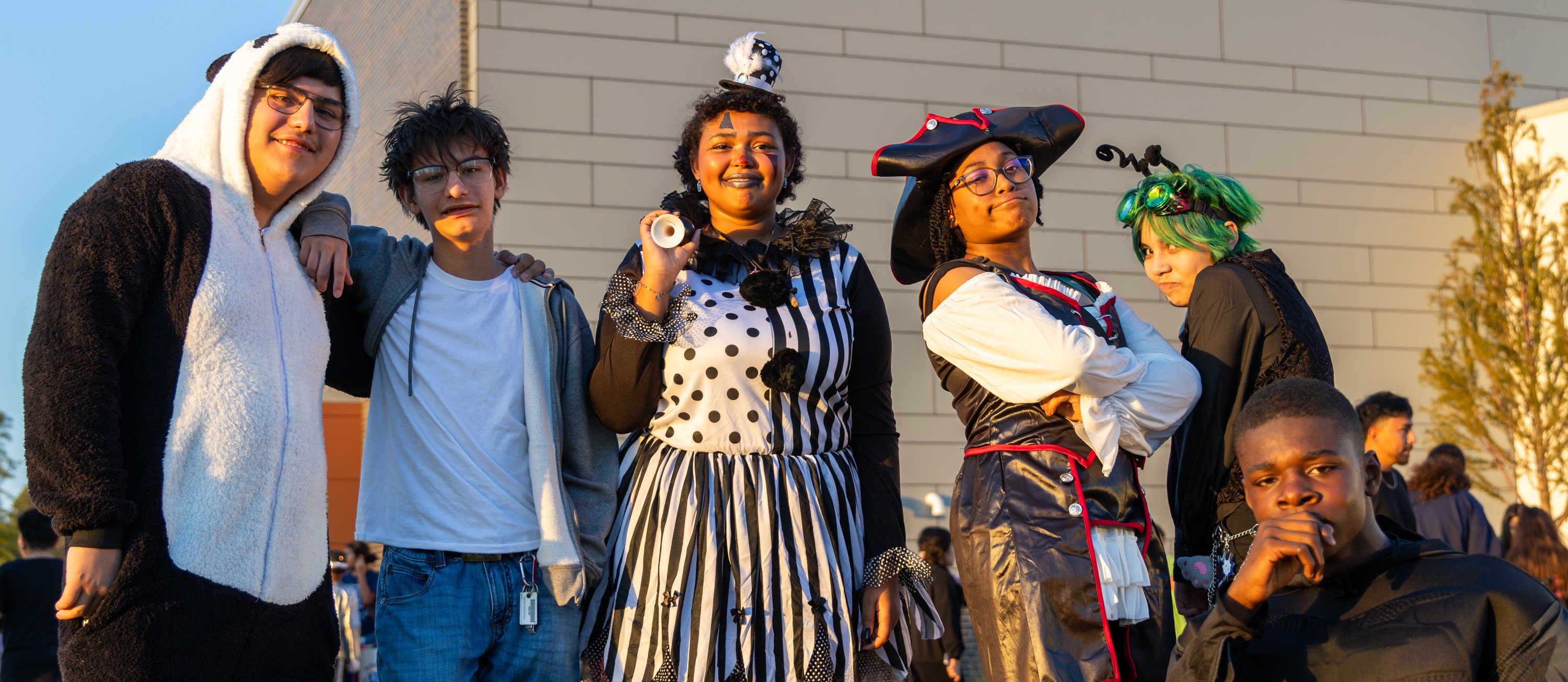 A group of PC West high school students pose together in creative Halloween costumes outside the Centennial Center.