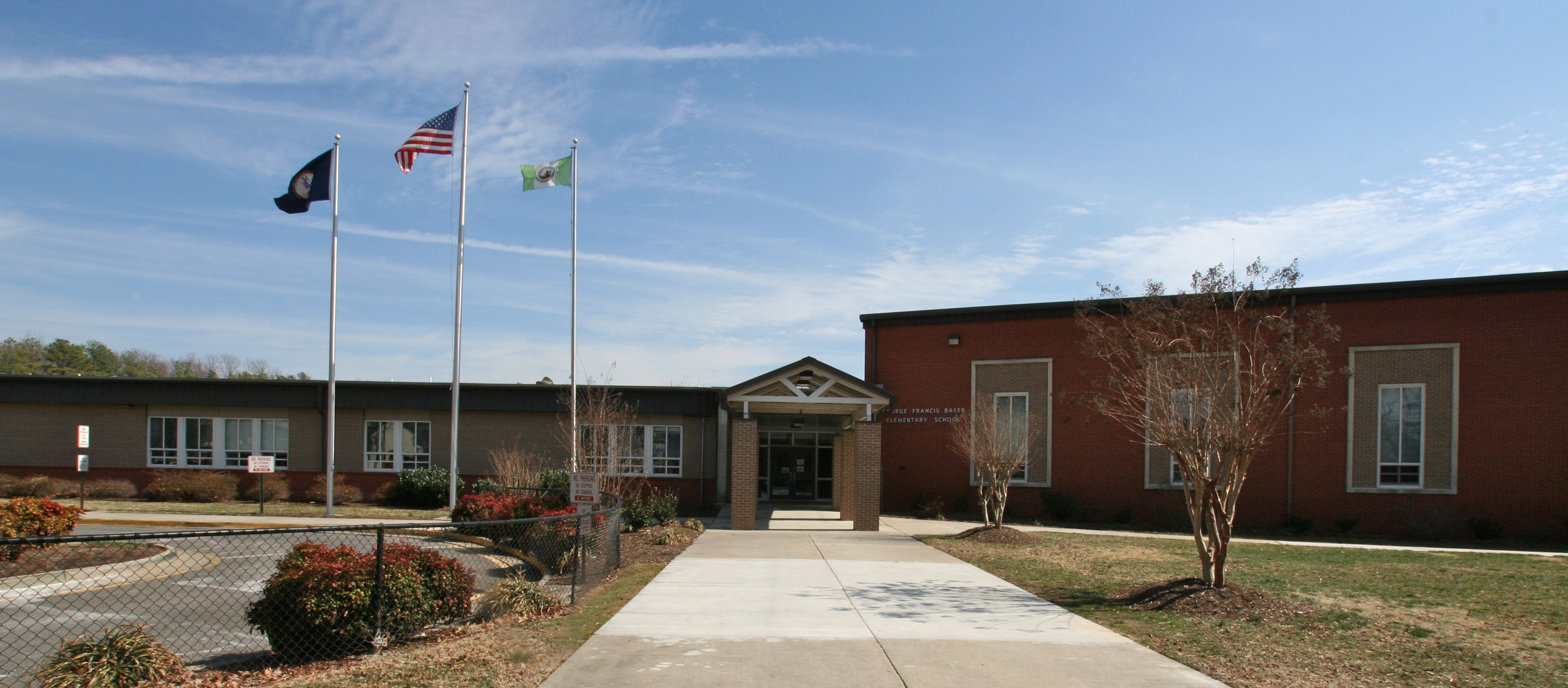 baker elementary building front with flags flying