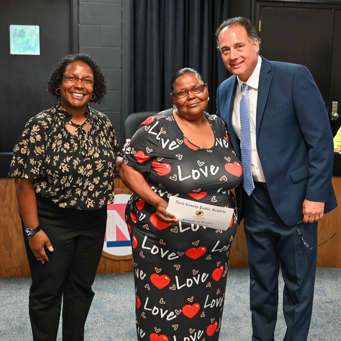 Photo of Dr. Washington, Sarita Lamm, and Dr. Ellis at the May board meeting accepting an award