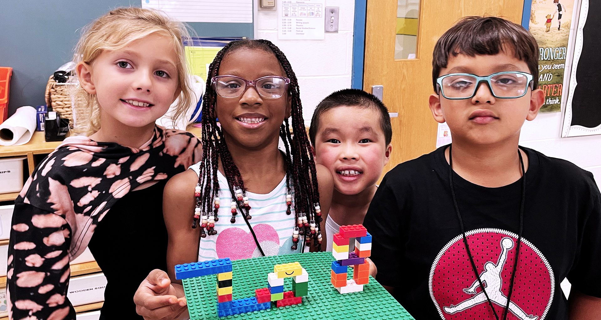 Four students show off their lego project