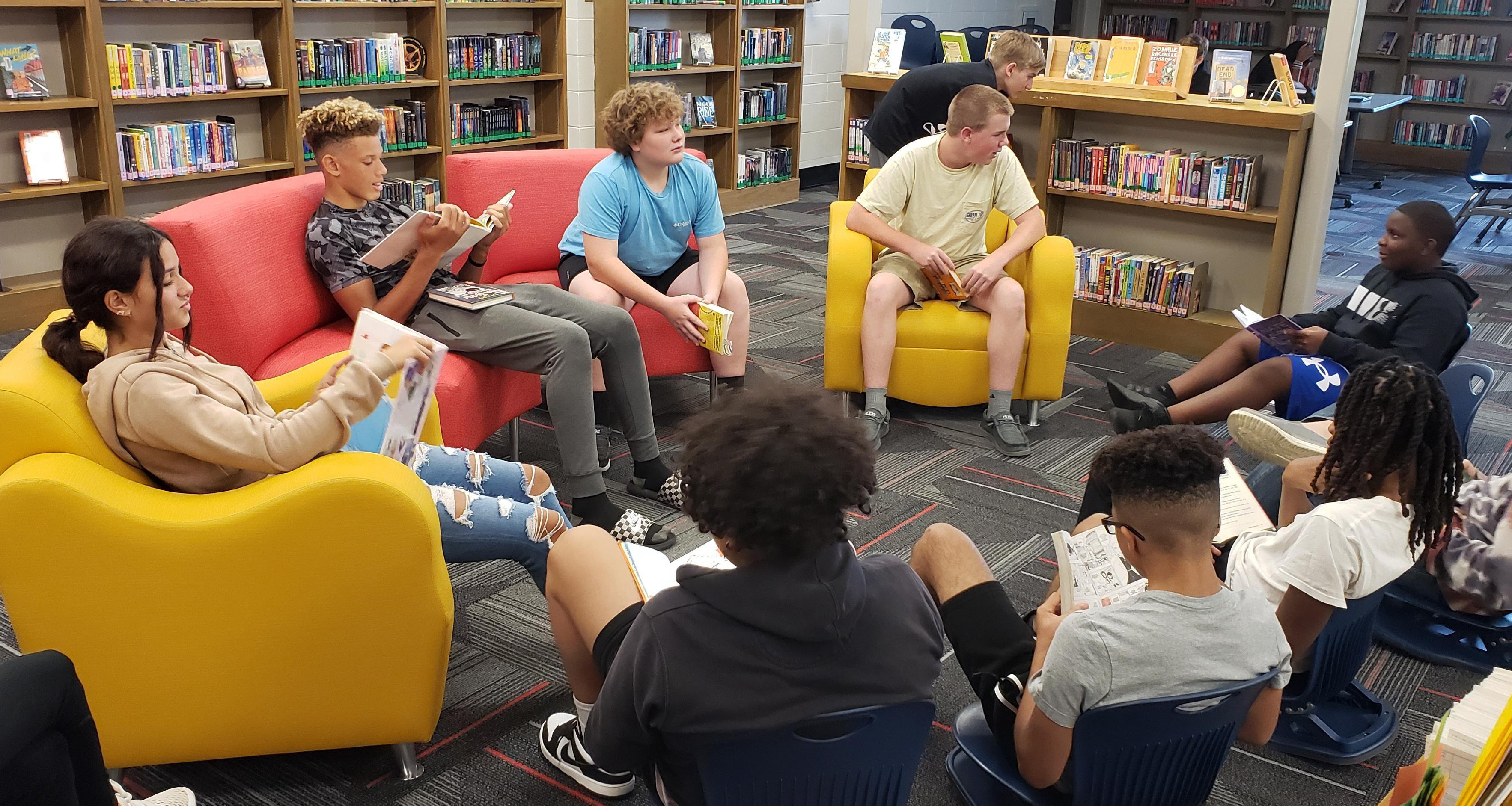 A group of students reading books in the library