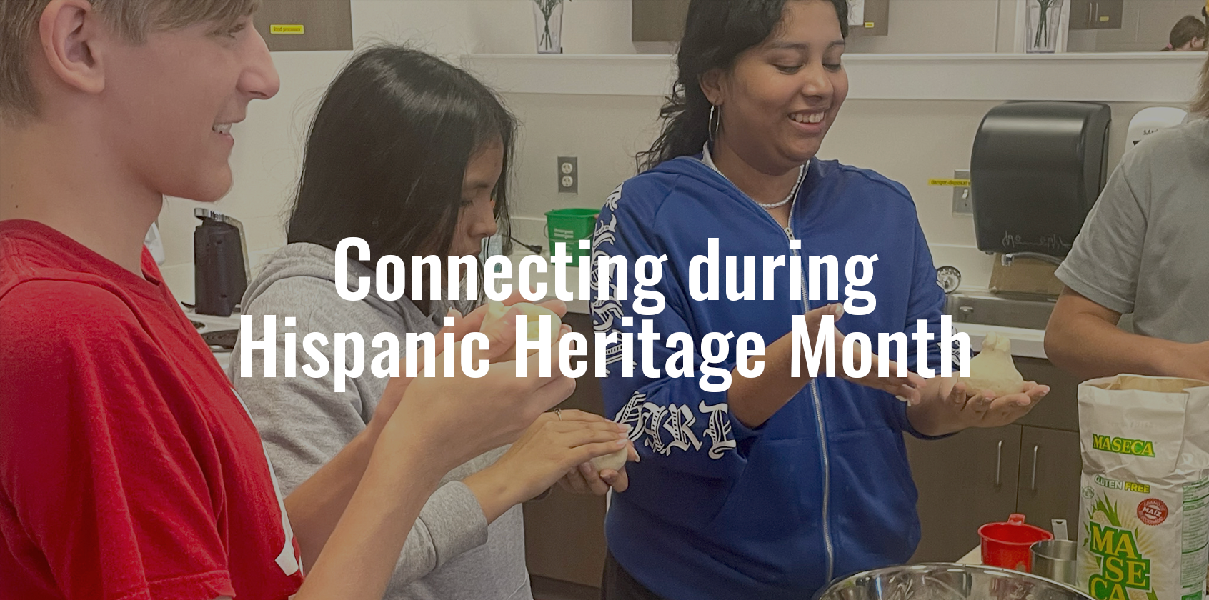Three students making pupusas in class