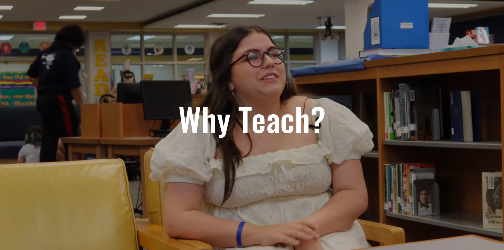 A future teacher is being interviewed in a school library about why she should teach