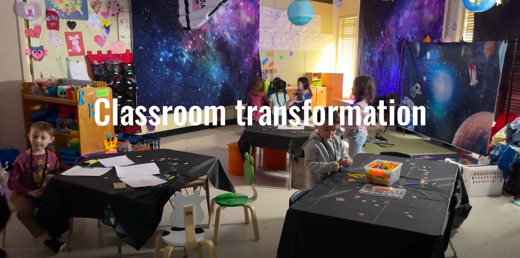Students in a dark classroom that is decorated with counterspace decorations.