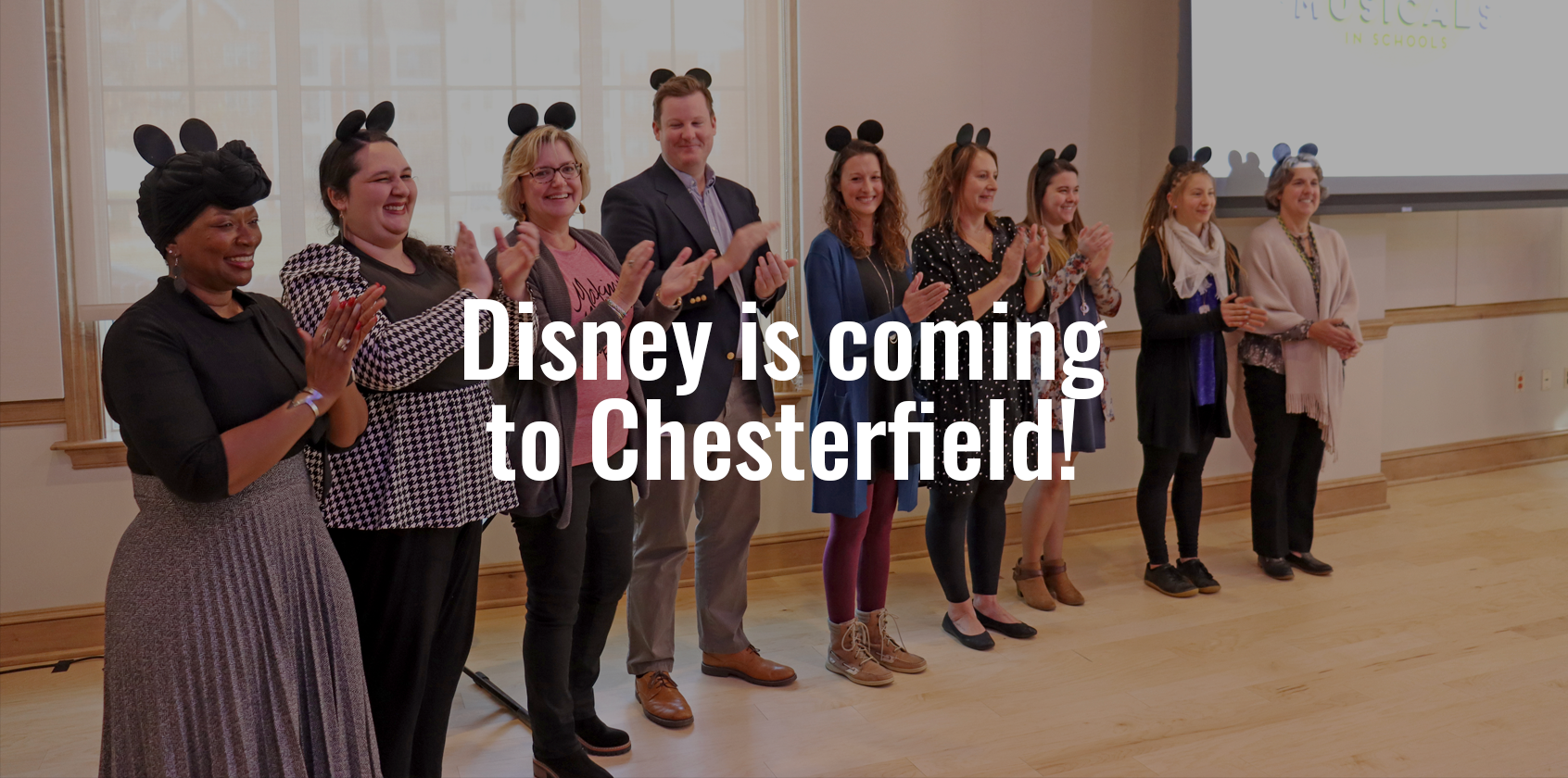 A group of administrators and teachers clapping